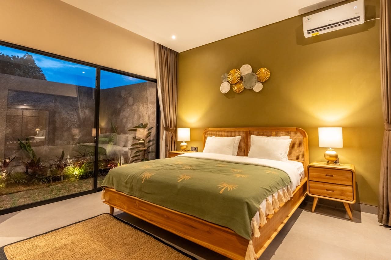 Garden Suite bedroom at night with garden view