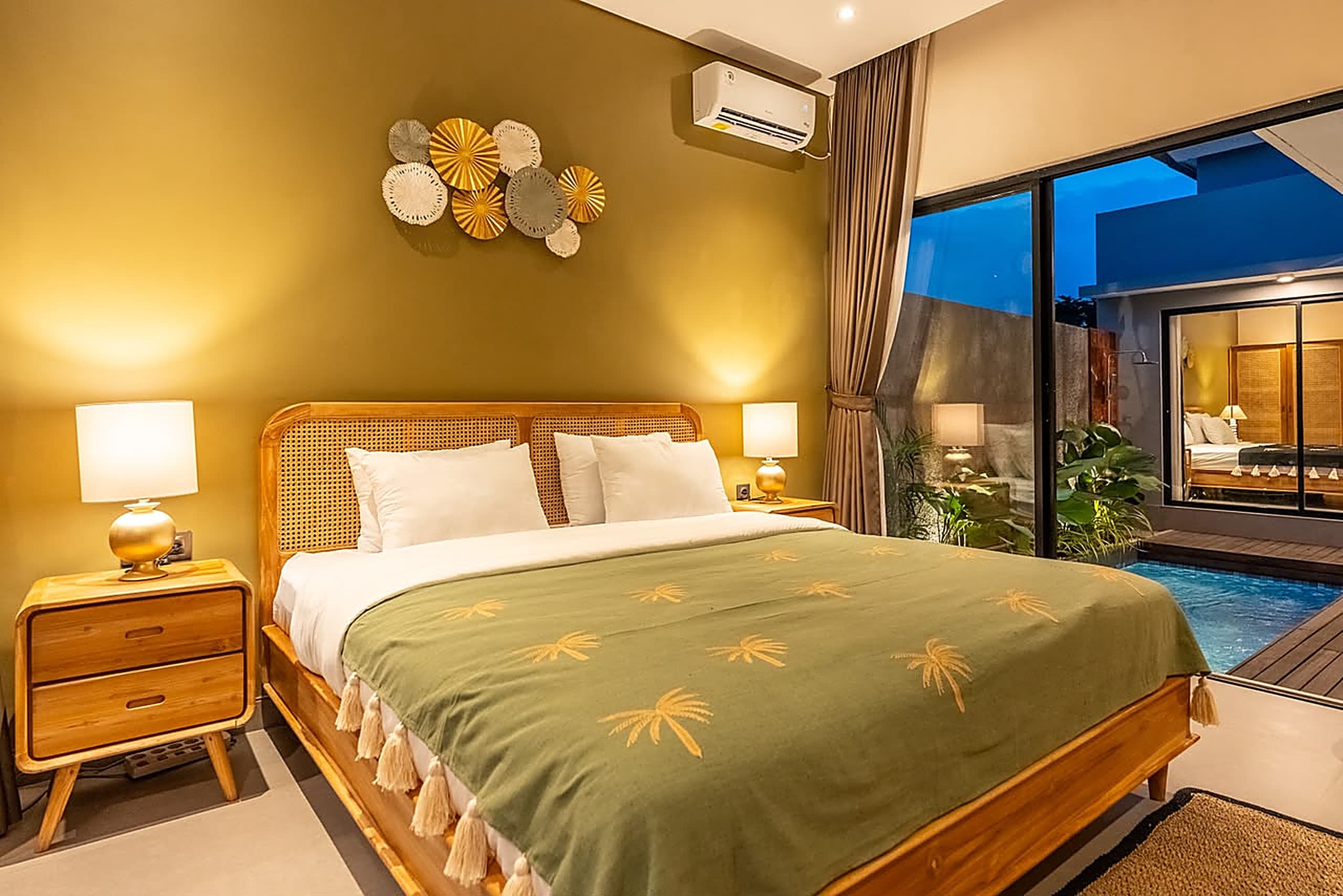 Bedroom suite opening onto the pool deck at dusk