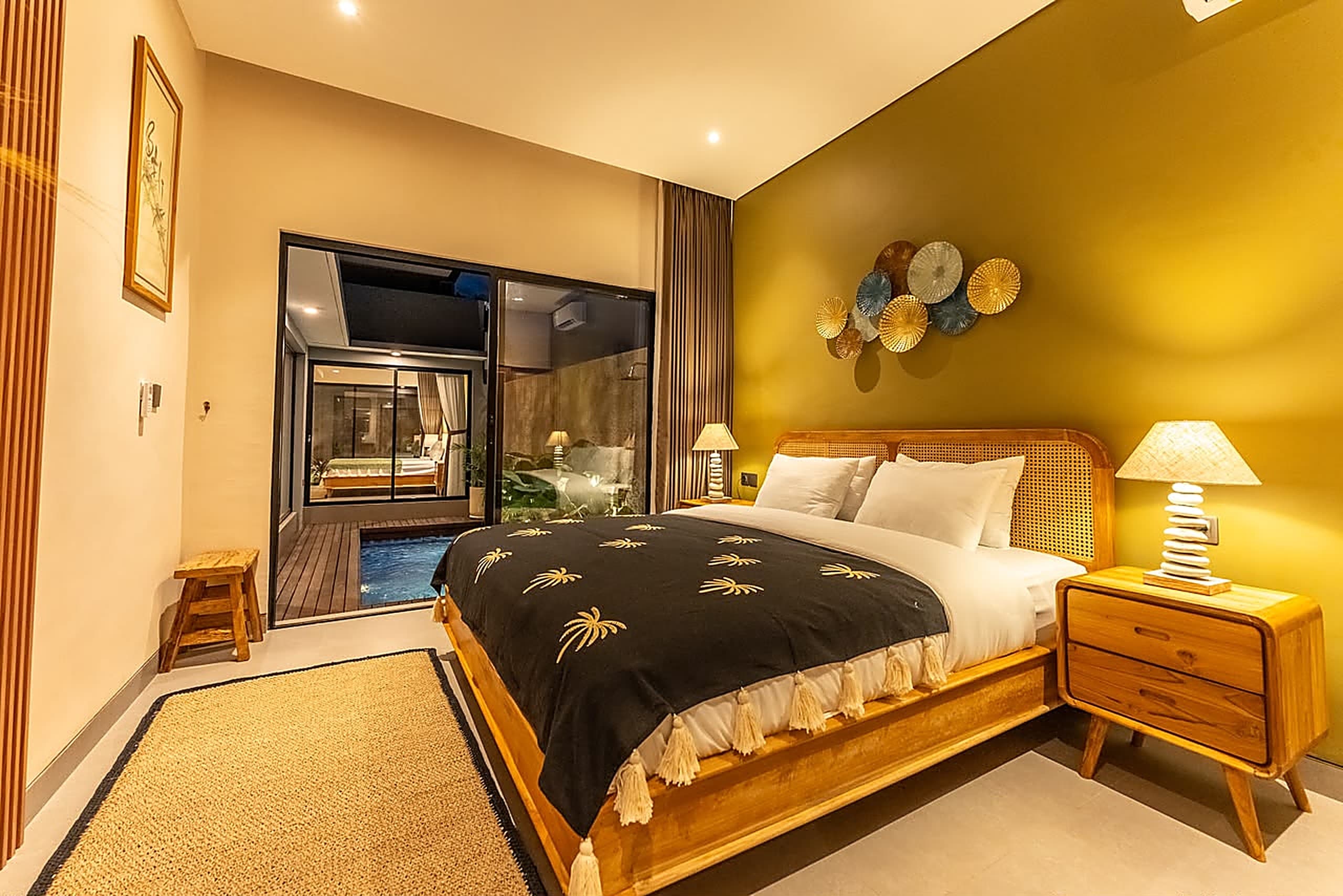 Bedroom suite reflecting the pool at night