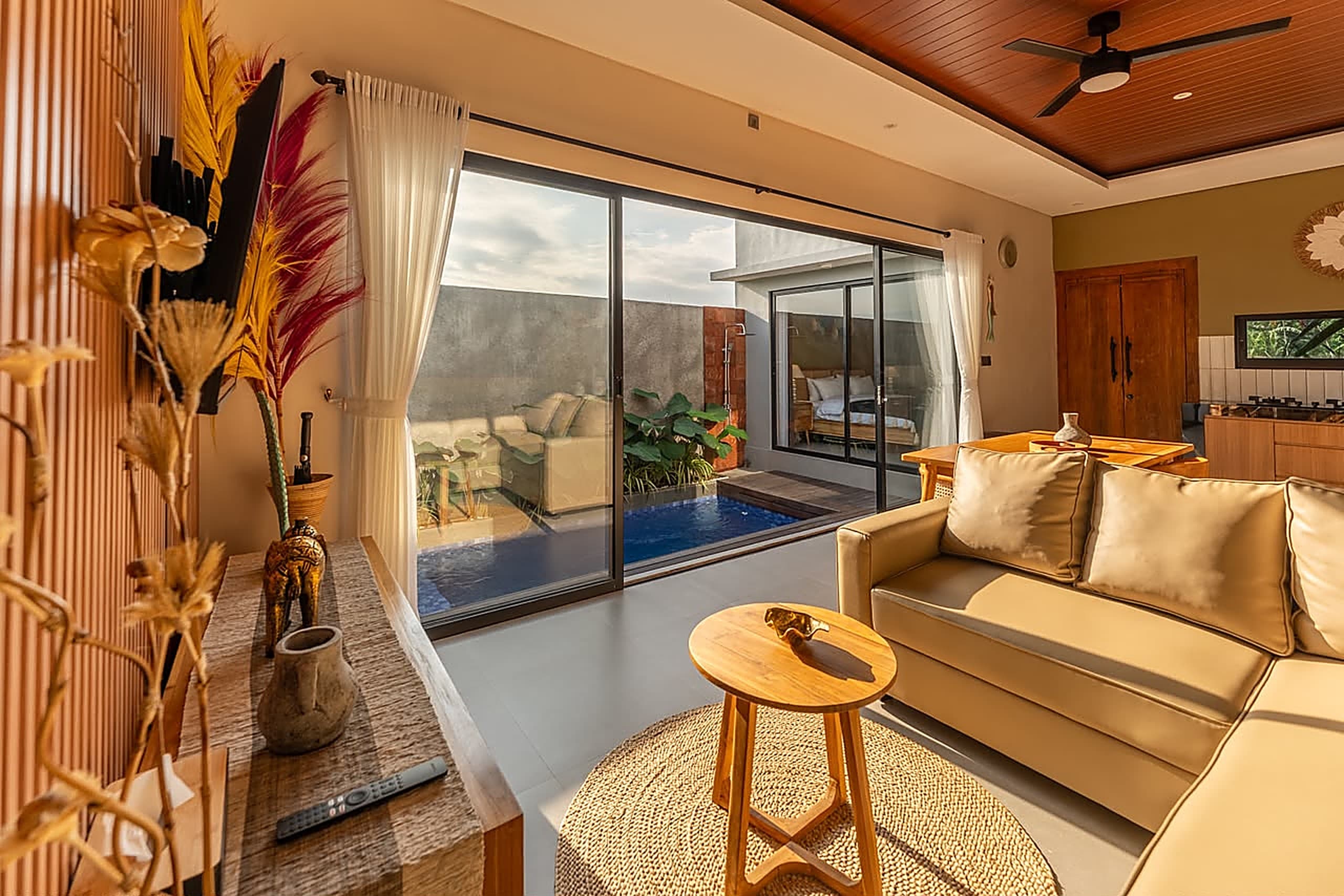 Living room sofa with sliding doors open to the pool